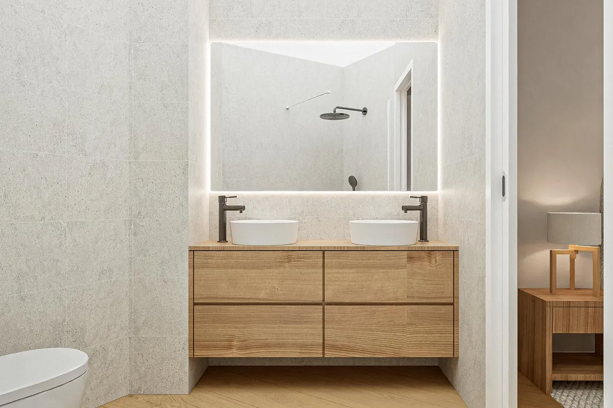 Baño con doble lavabo sobre mueble de roble